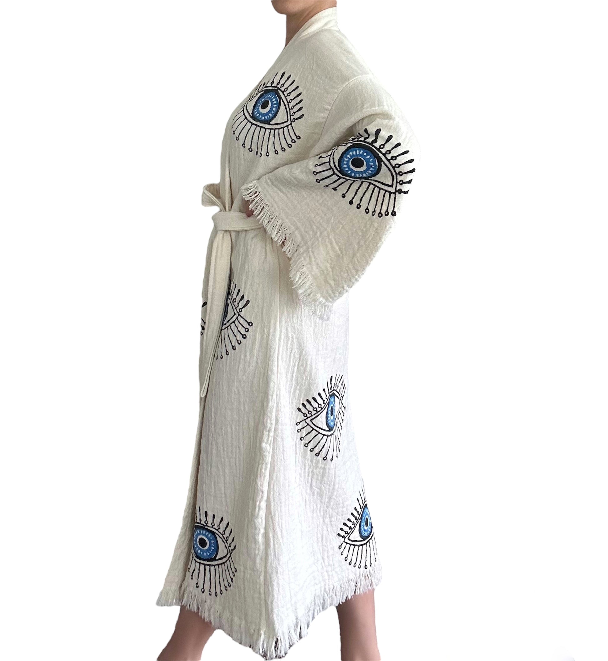 detail of blue evil eye pattern on natural turkish cotton muslin kimono robe